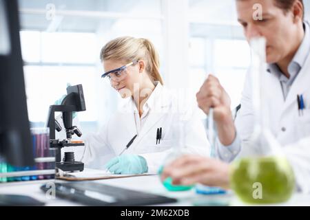 Analyzing samples. Two researchers hard at work in the laboratory. Stock Photo