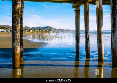 Cayucos, California, USA- December 25, 2022. Under the pier. Cayucos beach on California's central coast Stock Photo