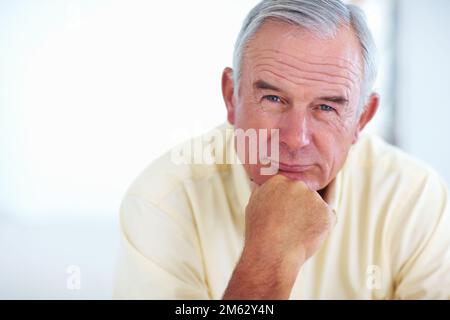 Mature man looking at you. Portrait of handsome mature man at home looking you. Stock Photo