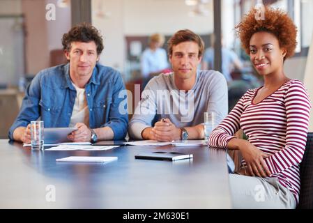 Weve got a great new project that were working on. a group of colleagues collaborating with each other on a project in an office. Stock Photo