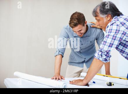 Man discussing home renovation plan with contractor. Young man discussing home renovation plan with architect. Stock Photo