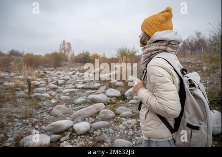Slow and not deep mountain river with rounded stones Stock Photo