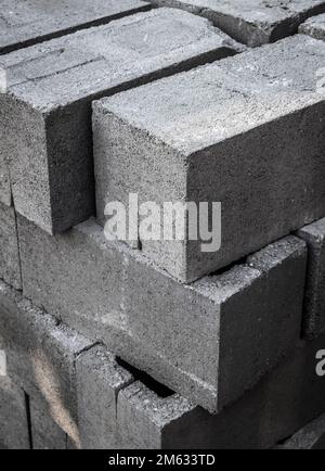 Large stack of gray concrete building blocks. Stock Photo