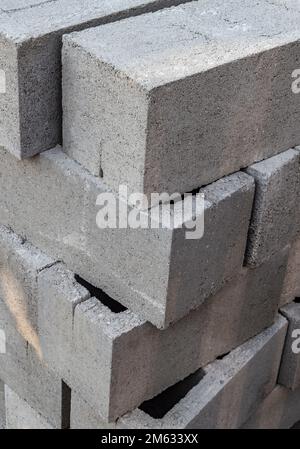 Large stack of gray concrete building blocks. Stock Photo