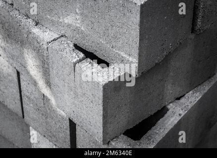 Large stack of gray concrete building blocks. Stock Photo