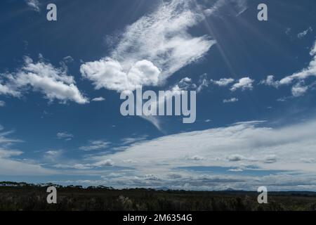 Cloudy blue sky with sunrays. Stock Photo