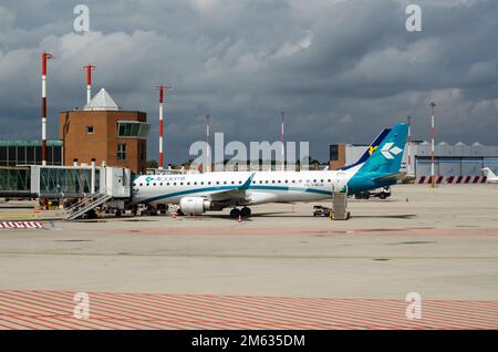Venice, Italy - April 19, 2022: Embraer E195LR aircraft belonging to the Air Dolomiti regional airline at an airbridge at Marco Polo Airport in Venice Stock Photo