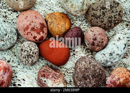Top view of different types of rocks with various sizes colors and shapes as background Stock Photo
