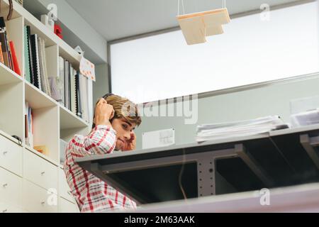 Young Entrepreneur Listening to Music at the Office Stock Photo