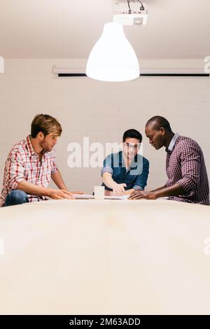 Three Architects and engineers working at the Office Stock Photo