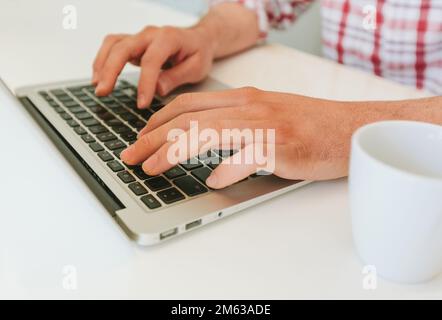 Anonymous man typing on a Modern Laptop Stock Photo
