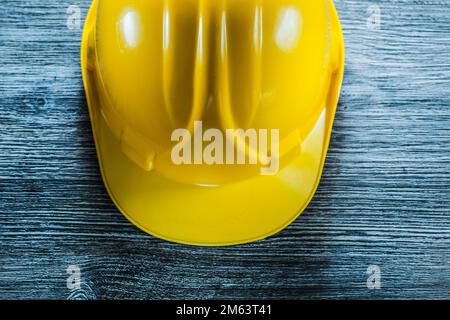 Yellow safety cap on wooden board. Stock Photo