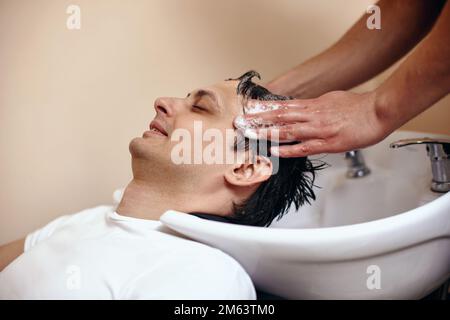 Barber washing hair of caucasian man , close-up Stock Photo