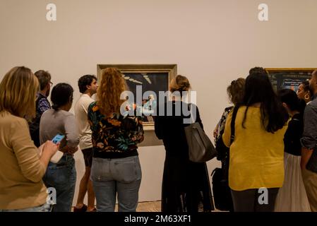 Curator explaining the painting Automat, 1927, Edward Hopper's New York exhibition, 2022, Whitney Museum of American Art, New York City, USA Stock Photo