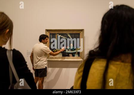 Curator explaining the painting Automat, 1927, Edward Hopper's New York exhibition, 2022, Whitney Museum of American Art, New York City, USA Stock Photo