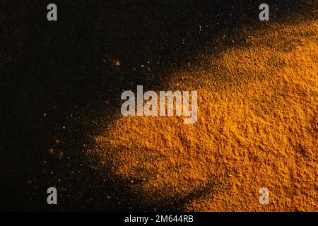 Yellow color powder explosion on black background Stock Photo