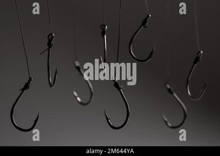 A fishing hooks hanging on a fishing line on a black background
