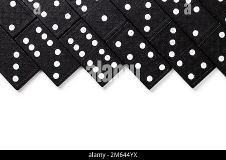 Black dominoes on a white background, top view. Board game. Place for text. Stock Photo