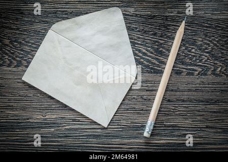 Vintage envelope pencil on black board. Stock Photo