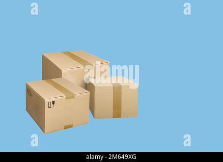 Cardboard parcel boxes on a blue background Stock Photo