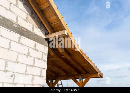 The edge of the roof connected to the terrace is completely covered with boards, raw walls are visible. Stock Photo