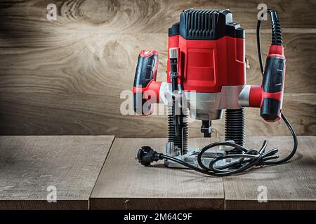 Red speed variable power small plunge router milling machine portable electric hand mini wood router on vintage wooden background Stock Photo