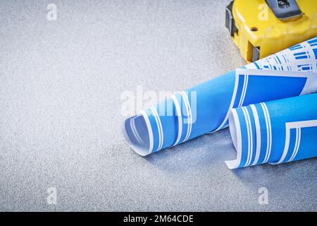 Tape-measure blue engineering drawings on grey background construction concept. Stock Photo