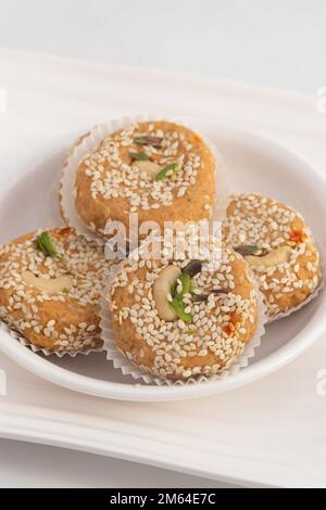 Winter Season Special Traditional Punjabi Mithai Til Tikki Or Tilkut Gud Mawa Bati Is Made Of Dry Roasted Sesame Seeds With Mava, Khoya, Jaggery, Gur, Stock Photo