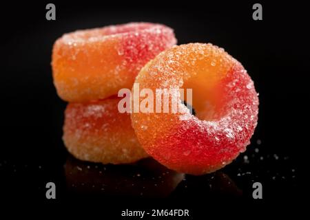 Sweets peach ring gummy candies on black. Stock Photo