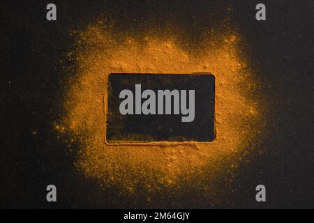 Frame made of yellow powder on a black background. concept. Stock Photo