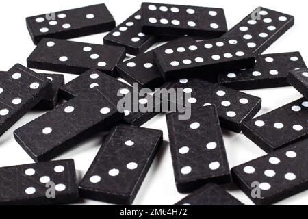 Playing dominoes on a white table. Domino effect. Stock Photo