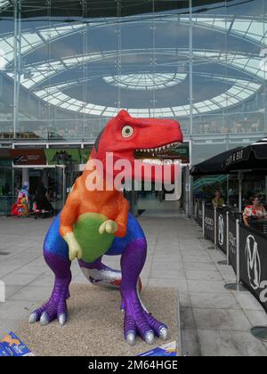 Prideasauras outside The Forum, part of the 2021 Norwich GoGoDiscover T-Rex Sculpture Trail of 21 Tyrannosaurus-Rex sculptures, Norwich, Norfolk, UK Stock Photo