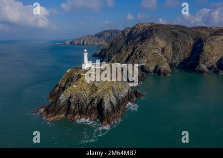 Panoramic photo of South Stack Lighthouse near Holyhead Anglesey aerial taken from out at sea showing the island and rocky cliffs Stock Photo