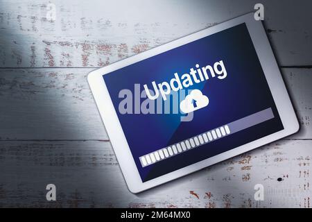 Top view of digital tablet updating software screen. System engineer and programming. Software apps developer. Stock Photo