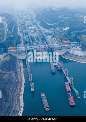 (230102) -- YICHANG, Jan. 2, 2023 (Xinhua) -- This aerial photo taken on Jan. 2, 2023 shows ships passing through the five-tier ship locks of the Three Gorges Dam in Yichang, central China's Hubei Province. The shipping throughput of the Three Gorges Dam, the world's largest hydropower project, hit a new record in 2022, the Three Gorges Navigation Authority said Monday. ?? The project's total throughput reached 159.8 million tonnes in 2022, an increase of 6.12 percent year on year. ?? In 2022, the cargo throughput of the project was 159.65 million tonnes, a year-on-year increase of 6.53 perce Stock Photo