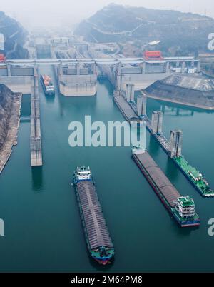 (230102) -- YICHANG, Jan. 2, 2023 (Xinhua) -- This aerial photo taken on Jan. 1, 2023 shows ships passing through the five-tier ship locks of the Three Gorges Dam in Yichang, central China's Hubei Province. The shipping throughput of the Three Gorges Dam, the world's largest hydropower project, hit a new record in 2022, the Three Gorges Navigation Authority said Monday. ?? The project's total throughput reached 159.8 million tonnes in 2022, an increase of 6.12 percent year on year. ?? In 2022, the cargo throughput of the project was 159.65 million tonnes, a year-on-year increase of 6.53 perce Stock Photo