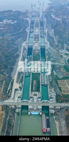 (230102) -- YICHANG, Jan. 2, 2023 (Xinhua) -- This aerial photo taken on Jan. 2, 2023 shows ships passing through the five-tier ship locks of the Three Gorges Dam in Yichang, central China's Hubei Province. The shipping throughput of the Three Gorges Dam, the world's largest hydropower project, hit a new record in 2022, the Three Gorges Navigation Authority said Monday. ?? The project's total throughput reached 159.8 million tonnes in 2022, an increase of 6.12 percent year on year. ?? In 2022, the cargo throughput of the project was 159.65 million tonnes, a year-on-year increase of 6.53 perce Stock Photo
