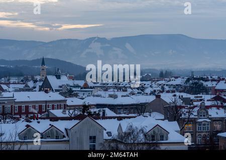 Townscape of Cesky Tesin, Moravian silesian region, Czech Republic, snow covered roofs and beskid mountains in the background Stock Photo