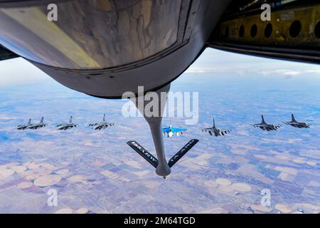 Eight F-16 Fighting Falcons assigned to the 114th Fighter Wing, fly behind a KC-135 Stratotanker from the 185th Air Refueling Wing while traveling to Weapons and Tactics Instructor (WTI) course 2-22 at Marine Corps Air Station Yuma, Ariz., April 1, 2022. WTI is a seven-week training event hosted by Marine Aviation Weapons and Tactics Squadron One (MAWTS-1), providing standardized advanced tactical training and certification of unit instructor qualifications to support Marine aviation training and readiness, and assists in developing and employing aviation weapons and tactics. Stock Photo