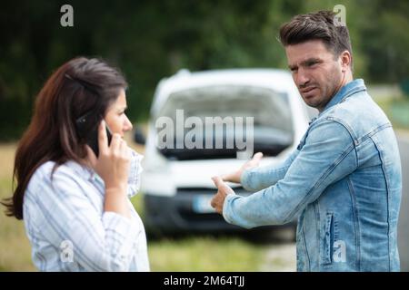 female motorist involved in car accident calling insurance company Stock Photo