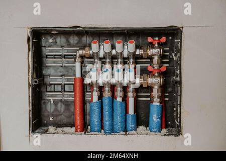 Underfloor heating water manifold with pump mixing valve Stock Photo
