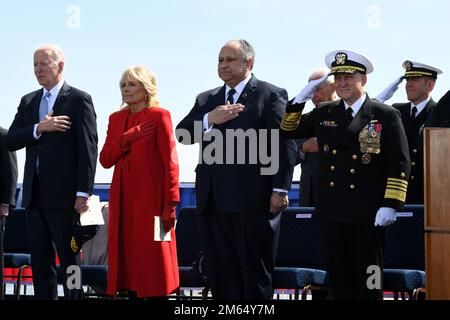 220402-N-GR655-0463 WILMINGTON, Delaware (April 2, 2022) – President of the United States Joe Biden, First Lady Jill Biden, Secretary of the Navy Carlos Del Toro, and Chief of Naval Operations Adm. Mike Gilday stand during the national anthem during a commissioning commemoration ceremony for the Virginia-class submarine USS Delaware (SSN 791) in Wilmington, Delaware April 2, 2022. The initial commissioning took place administratively in April 2020 due to COVID restrictions at the time and is the first submarine to be commissioned while submerged. Delaware, the seventh U.S Navy ship and first s Stock Photo