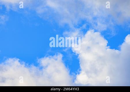 Puffy white clouds and blue sky on sunny day Stock Photo
