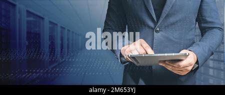 Big Data and Data Science. Male Specialist Using tablet in Big Data Center. High Speed Data Transfer, Server Transfer, Technology Science Breakethroug Stock Photo