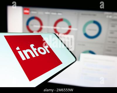 Smartphone with logo of American enterprise software company Infor on screen in front of business website. Focus on center of phone display. Stock Photo