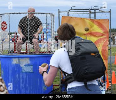 Col. Jason Grandy, 919th Special Operations Wing commander, sits in a dunk tank during the unit's 50th Anniversary Wing Day event at Duke Field, Florida, April 2, 2022. The Wing Day festivities also included axe throwing, a bouncy castle, face painting, aircraft static displays, and a free lunch for 919th SOW military members and their families. Stock Photo