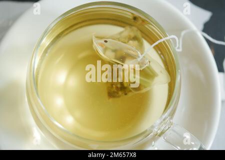 green tea and tea bag on table, close up. Stock Photo