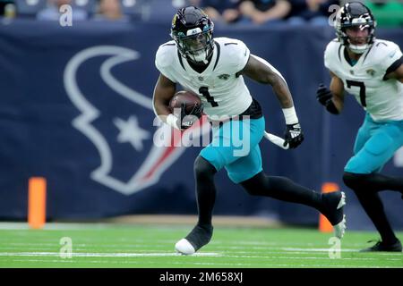 Houston, Texas, USA. 1st Jan, 2023. Jacksonville Jaguars running back Travis Etienne Jr. (1) carries the ball upfield during the game between the Houston Texans and the Jacksonville Jaguars at NRG Stadium in Houston, TX on January 1, 2023. (Credit Image: © Erik Williams/ZUMA Press Wire) Stock Photo