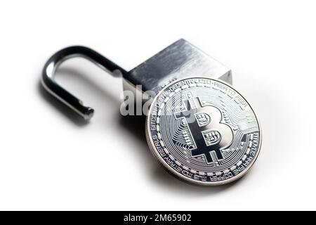 Digital currency, silver bitcoin with open padlock on white. Stock Photo