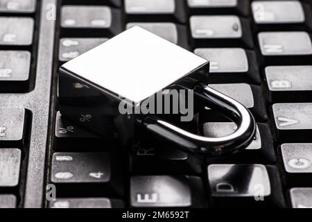 Computer security concept with a closed padlock on the keyboard. Stock Photo